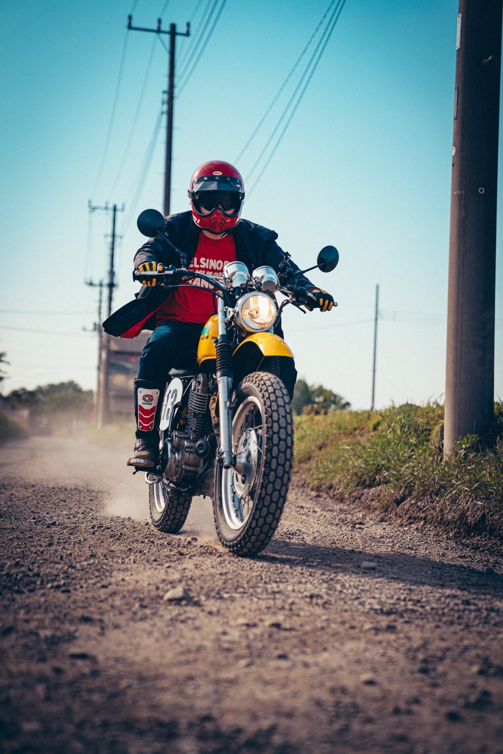 クラシックパターンのタイヤを装着したSR400で砂利道を走る様子